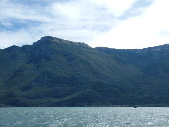 Monte Baldo und der Ort Malcesine vom gegenüberliegenden Ufer aus aufgenommen. Man kann den Startplatz West als riesige Wiese direkt am Kamm erkennen. Die Seilbahn befindet sich in der Schlucht in der Mitte des Bildes. Der Landeplatz müßte im Bild circa senkrecht darunter liegen.
Datum: 29.08.2006