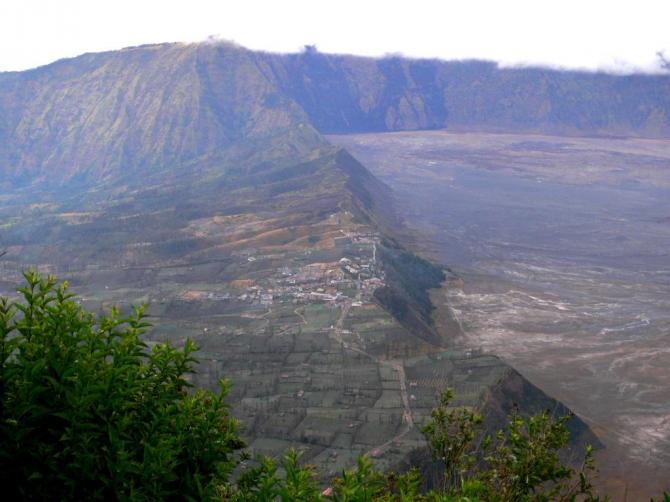 Blick vom Aussichtspunkt nach Cemoro Lawang. Einige der Hotels stehen direkt vorne an der Abbruchkante mit hervoragendem Blick auf die Vulkane